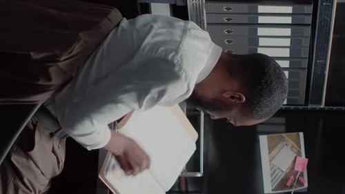 Man Reads Papers in Office