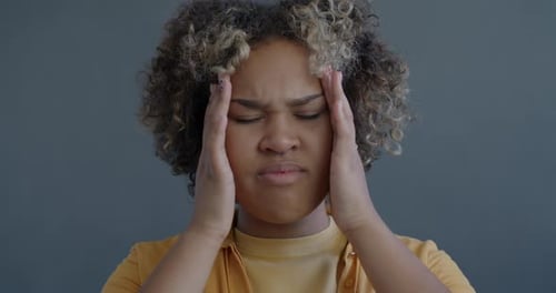 Woman Massaging Temples for Headache Relief