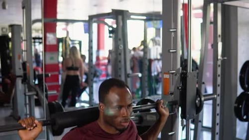 Black Bodybuilder Doing Squatting with a Barbell on Shoulder African Man Lifting Weight in Gym