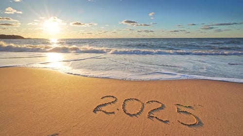 2025 year text symbol written on the seashore