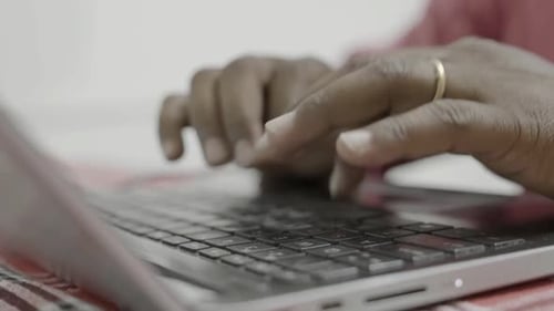 Hands Typing on Laptop Keyboard Close Up