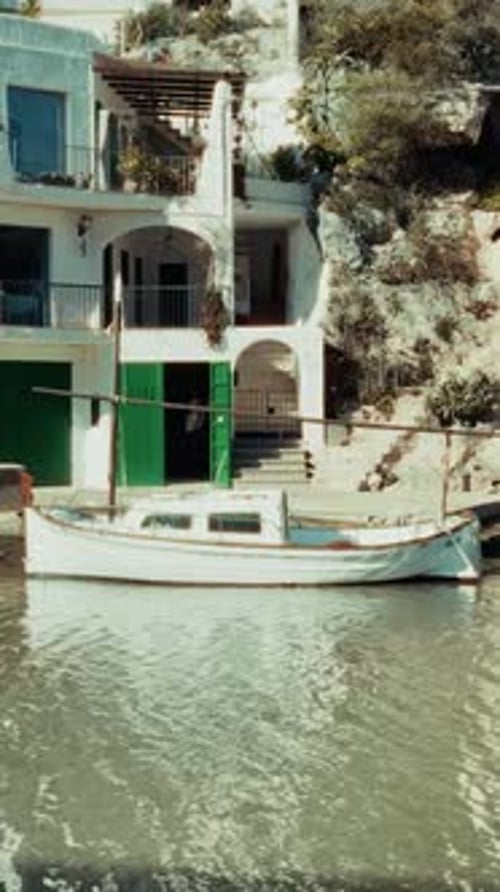 Beautiful vertical footage of boats cruising through Mallorca’s crystal-clear waters, with vibrant m