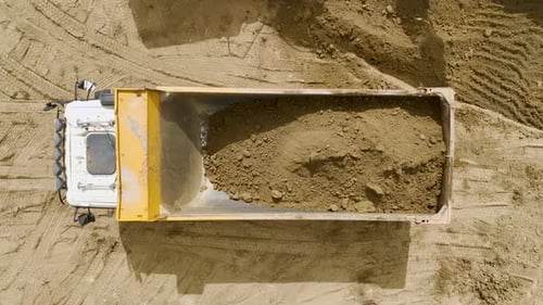 Early Construction Aerial View of Excavators and Trucks Removing Soil