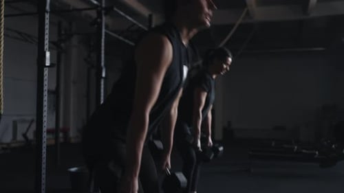 Intensive Power Workout In Fitness Club Group Of Athletic Women Doing Exercises With Dumbbells