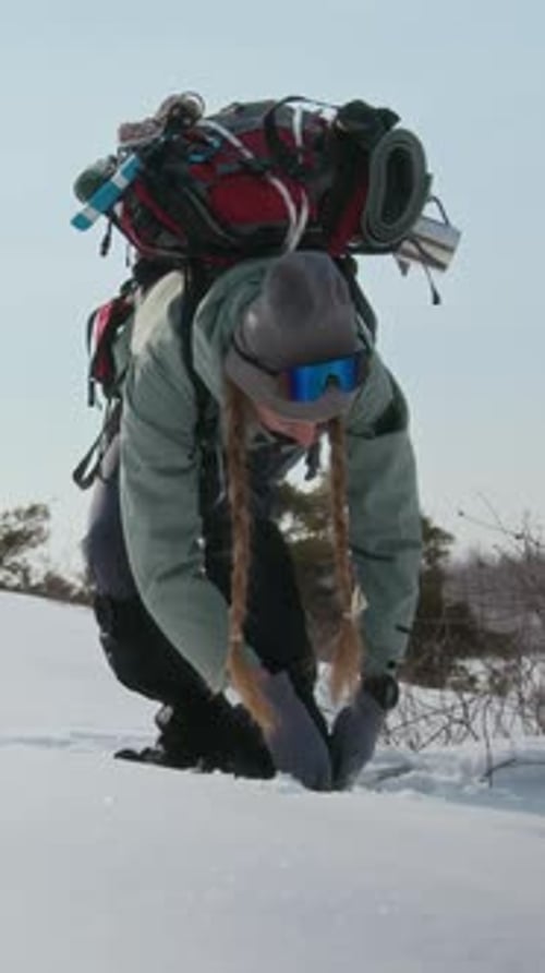 Woman Hiking on Snowshoes in Winter Landscape
