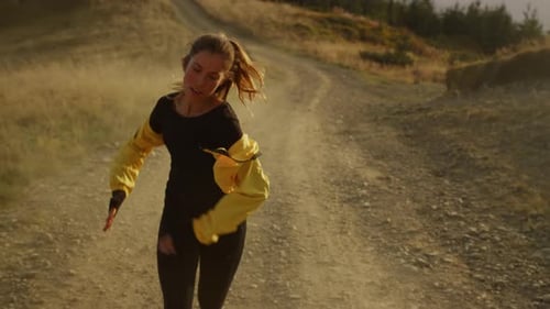 Tired Athlete Jogging on Dirty Road. Fitness Girl in Sportswear Running In