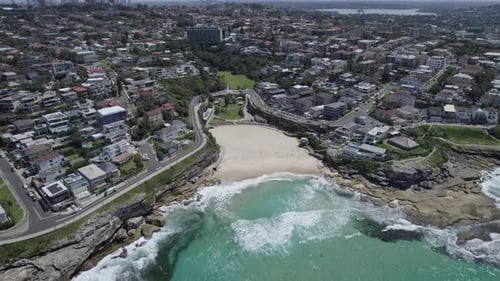 Ocean Wave Rolling Onto The Shore Of Tamarama Beach, Cove Beach And Park In Tamarama, NSW, Australia