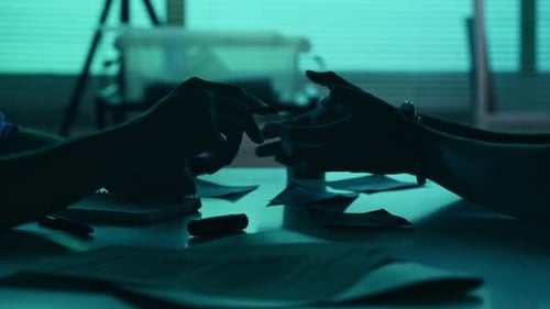 Close Up Detail Video of the Hands of a Suspect Offender Perpetrator or Prisoner and a Detective