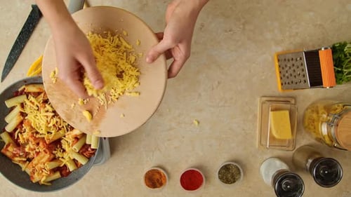 Pasta preparation, topping pasta with grated cheese, food