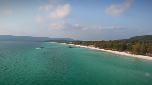 Aerial Panorama Of Beach And Ocean With Boats Floating On Turquoise Sea