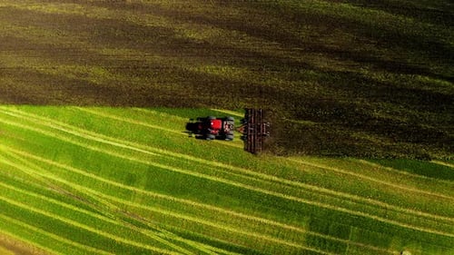 Red Tractor Plowing Field From Above