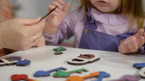 Child and Adult Fitting Keys into Locks Puzzle