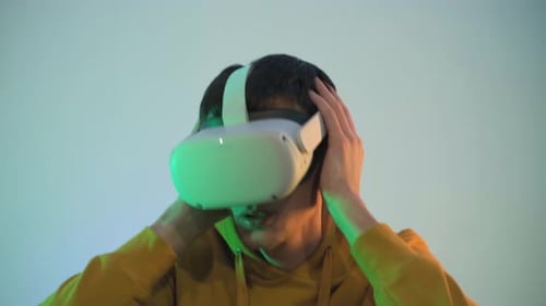 Young Adult Using Virtual Reality Headset Indoors