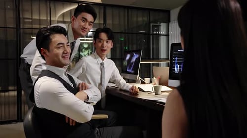 Business Team Congratulating Colleague in Modern Office Setting