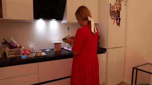 Woman Prepares Cake for a Birthday Celebration