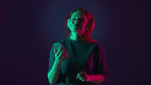 Woman Enjoying Music with Headphones and Smartphone