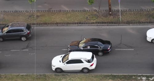 Luxury Cars And Vehicles Traveling At Two Lane Highway In Kyiv, Ukraine. wide shot