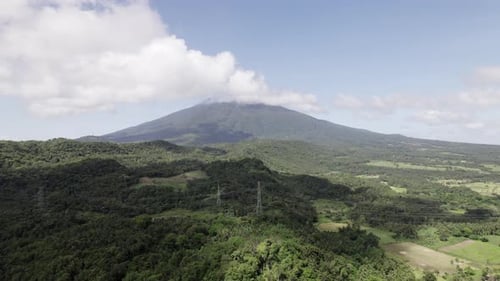 A Distant Mountain In Lush Green Forestation