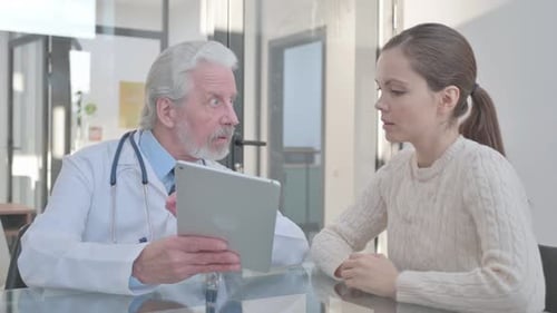 Doctor Discussing Diagnosis with Female Patient in Clinic
