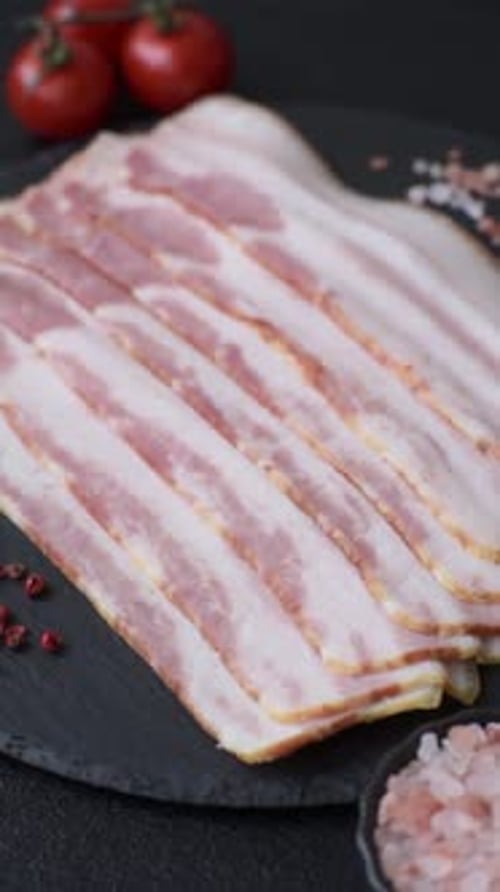 Raw smoked bacon slices, ham, jamon, or prosciutto strips for cooking. Raw bacon slices