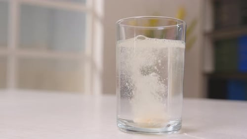 Effervescent Tablet Dissolving in Glass of Water