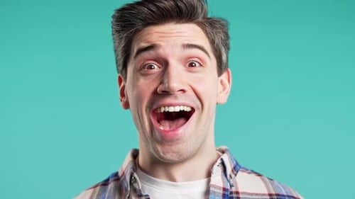 Man Smiling in Extreme Close Up on Turquoise