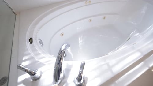 Water Pouring Into Luxury White Bathtub, Super Slow Motion Video.