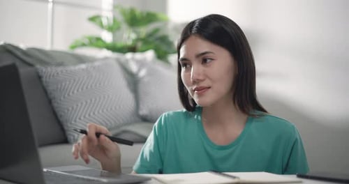 Woman Working on Laptop at Home