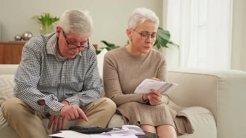 Senior Couple Reviewing Finances Together at Home