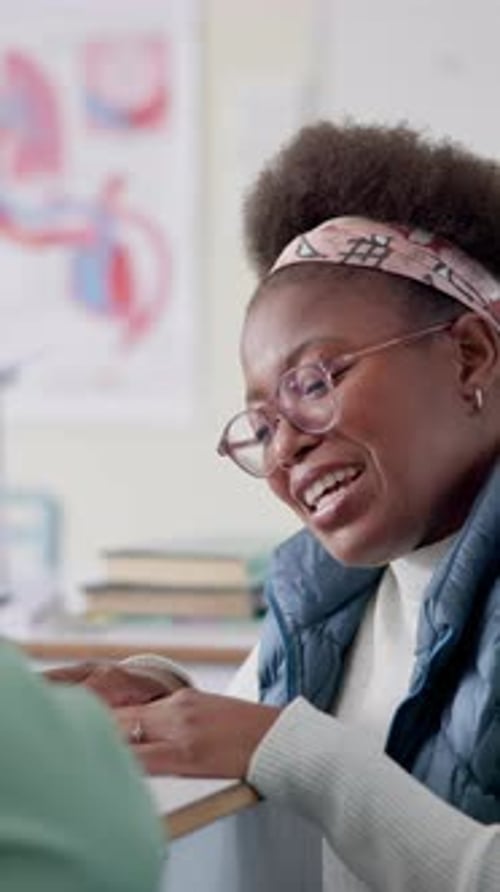 Young Adult Smiles While Sitting in Classroom
