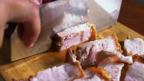 Cutting crispy pork belly. asian style crispy pork, close up
