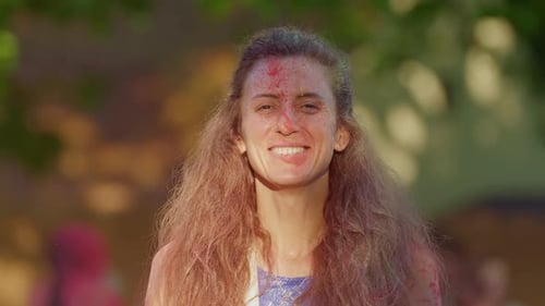 Woman Throws Colorful Powder During Holi Festival