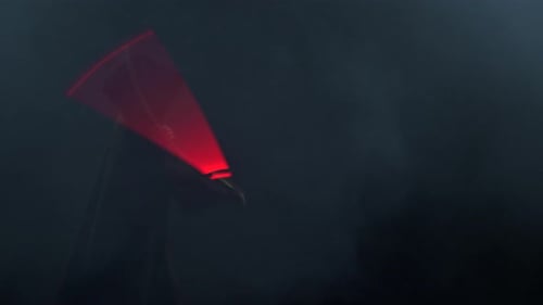 Young Man in Jedi Cosplay Costume with Lightsaber Battle on Black Background in Smoke and Rain Slow