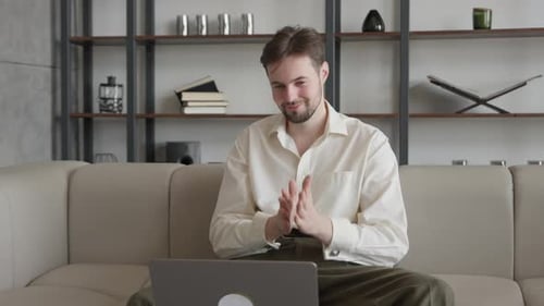 Young Adult Working Remotely from Home on Laptop