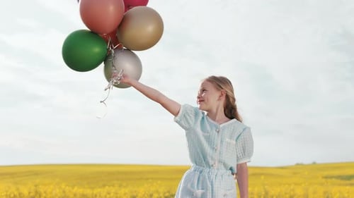 Girl with Balloons in Yellow Flower Field