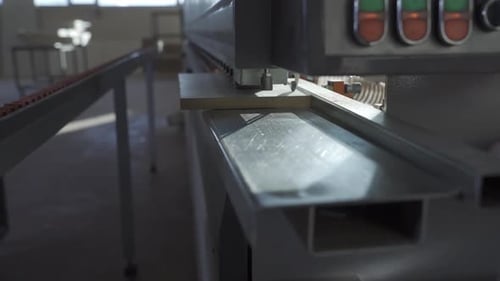 Edge banding machine in carpentry workshop.