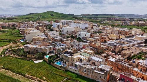 Aerial view of historic buildings and lush landscapes in Malta