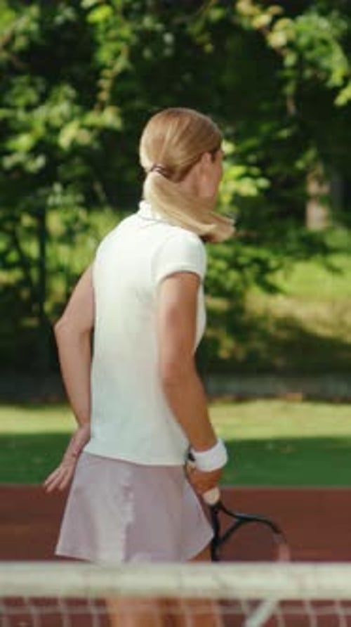 Woman Plays Tennis on Sunny Urban Court