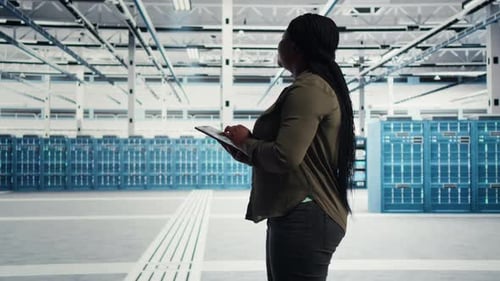 Un desarrollador de software de centro de datos realiza chequeos de equipos con un teléfono inteligente con pantalla verde