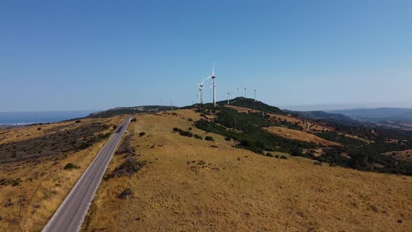 Rows of electricity windmills in Spain, aerial fly towards view ...