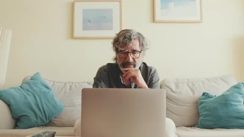 Man with Gray Hair Working on Laptop