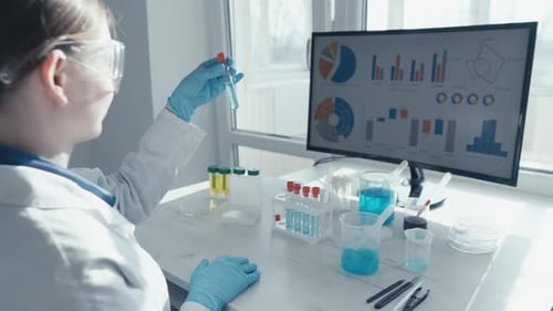Scientist Holds Test Tube in Bright Lab