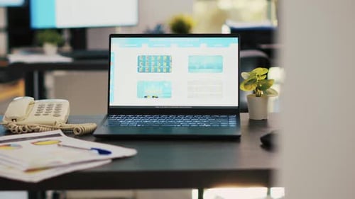 Stock Market Diagrams with Charts and Stock Figures on Laptop Sitting on Desk