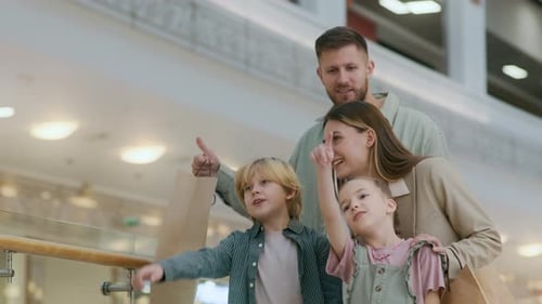 Siblings and Parents Choosing Root while Going Shopping in Mall