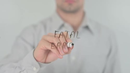 Man Writing Fatal Error on Clear Surface
