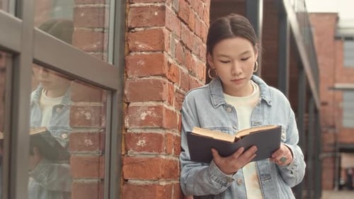 Portrait of Female Asian Student with Book Outside Campus