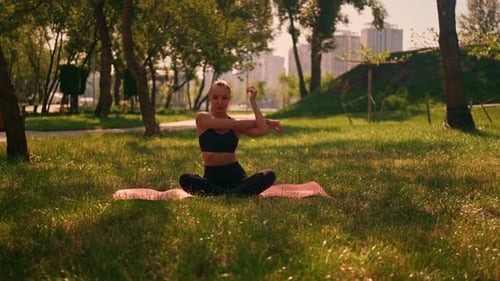 Woman Stretching Arms in Park Yoga Session