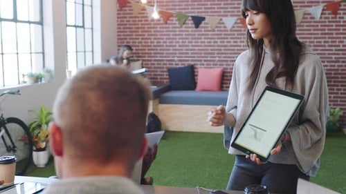 Digital marketing and advertising team manager with a tablet, presentation
