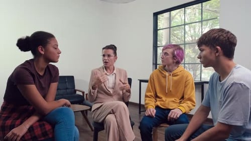 Group of People in Discussion Circle Indoors