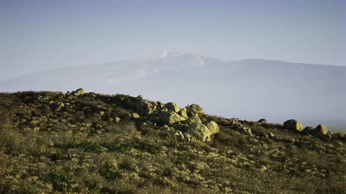 Hiking Route Across Rocky Terrain with Broad Mountain Landscape